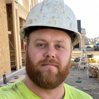 Jerry King, in a hard hat on a framing site